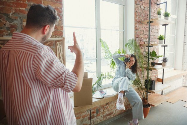 New life. Young couple moved to a new house or apartment. Look happy and confident