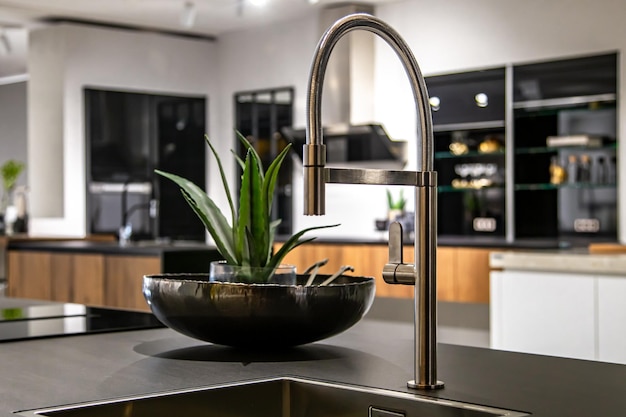 New modern steel faucet and kitchen room sink close up