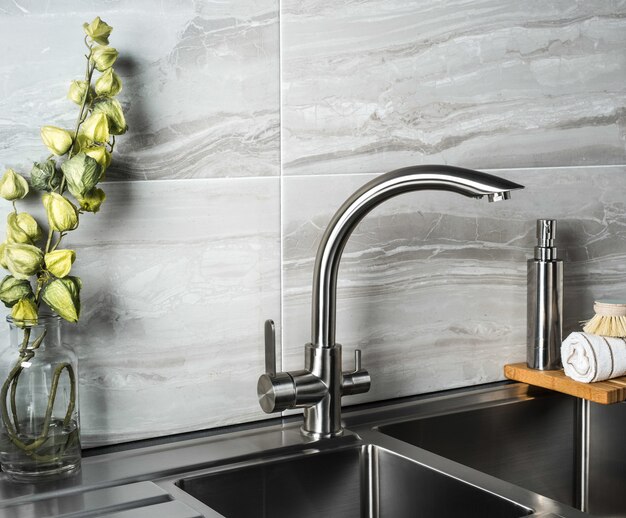 New and modern steel faucet in the kitchen