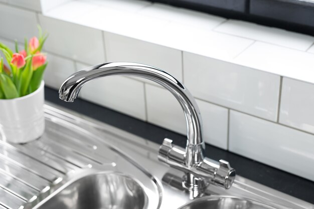 New and modern steel faucet in the kitchen