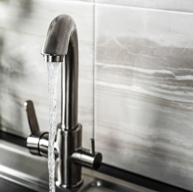 New and modern steel faucet in the kitchen