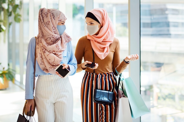 Free photo new normal hangout, muslim friends wearing mask