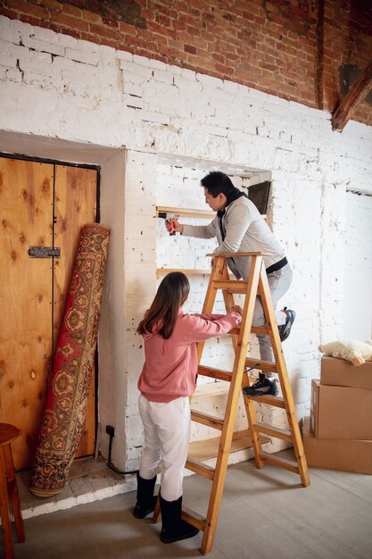 New property owners, young couple moving to new home, apartment, look happy