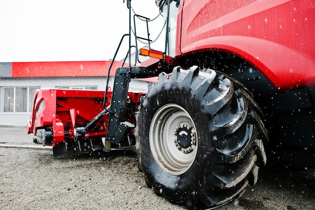 New red combine harvester at snowy weather