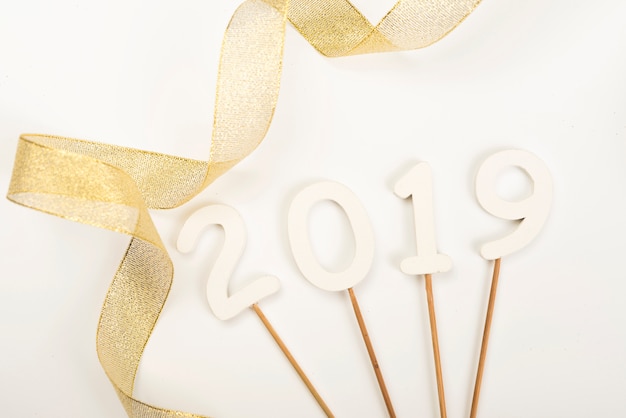 Free photo new year 2019 photo props lying near ribbon