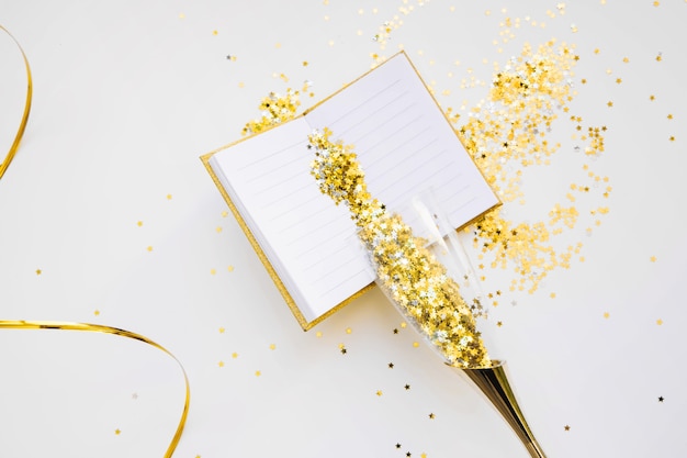 New year background with open book and golden confetti