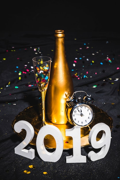 New Year composition of champagne and clock