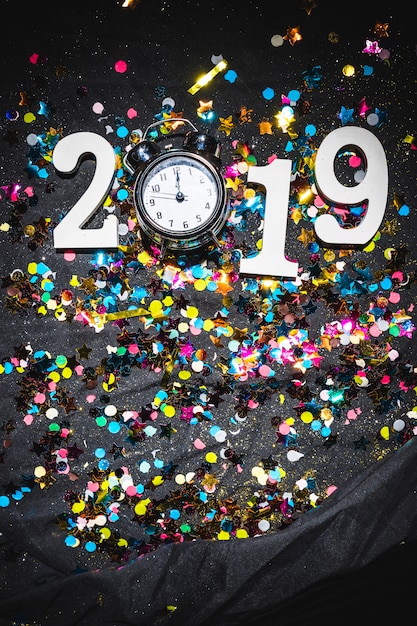 Free photo new year composition of clock and number 2019