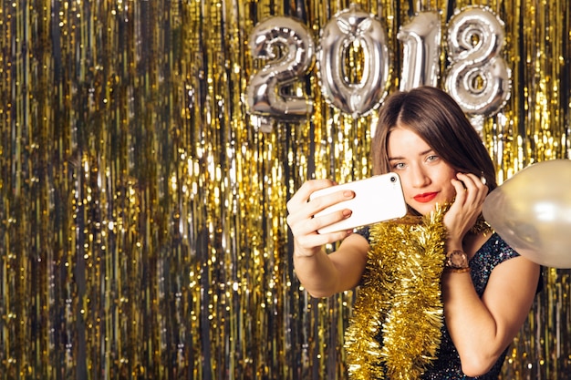 Free photo new year concept with girl taking selfie