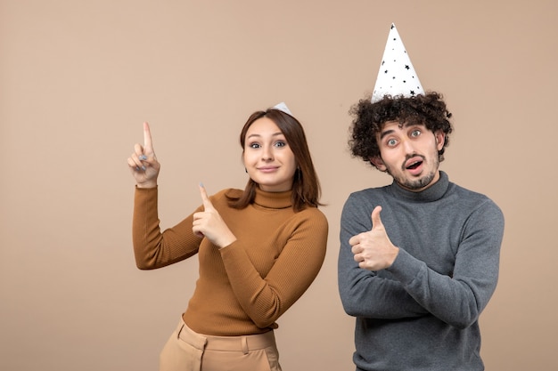 New year concept with lovely excited happy young couple wear new year hat on gray stock image
