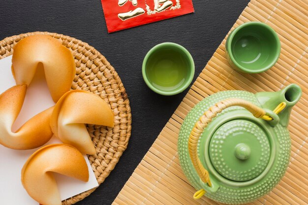 New year fortune cookies and set of green teapot and cups