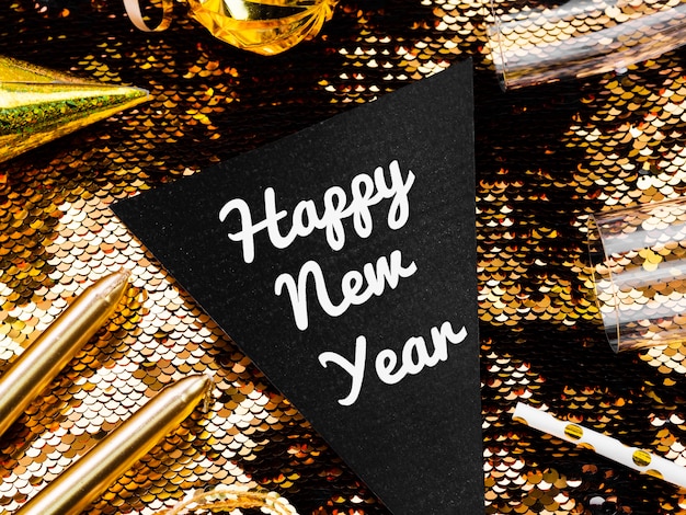 Free photo new year lettering on golden sequins background