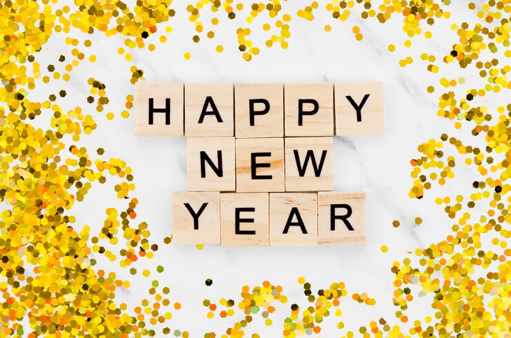 Free Photo new year lettering  surrounded by golden glitter