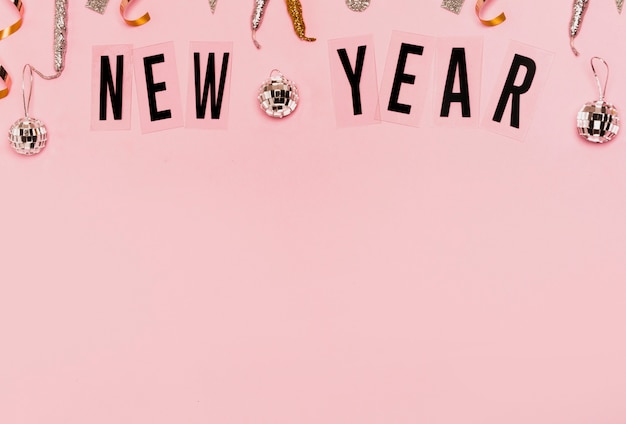 New year lettering with copy space pink background