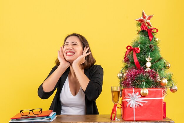 New year mood with beautiful business lady sitting at a table in the office