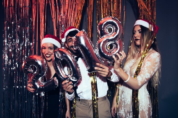 New year party concept with friends holding numbers