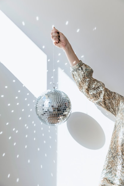 New year party concept with girl holding disco ball