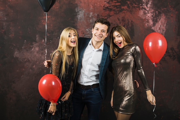 Free photo new year party concept with three happy friends