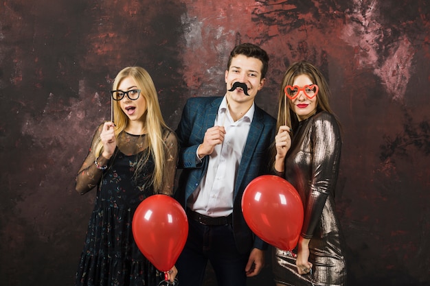 Free photo new year party concept with three joyful friends