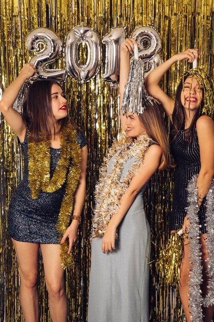 New year party with three girls celebrating