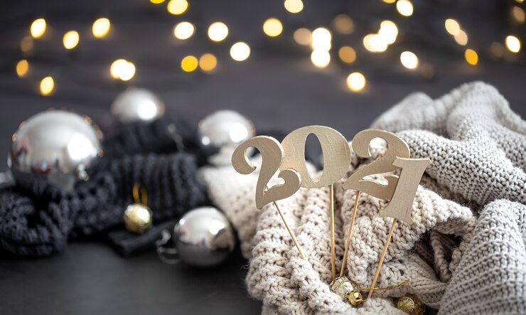 Free Photo new year's composition with wooden new years number and festive background.