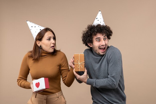 New year shooting with young couple wear new year hat emotional girl with heart and smiling guy