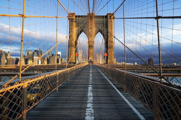 New York City Brooklyn Bridge in Manhattan closeup with skyscrapers and city skyline over Hudson River.