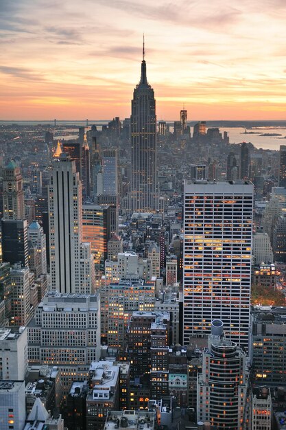 New York City skyline aerial view at sunset with colorful cloud and skyscrapers of midtown Manhattan.