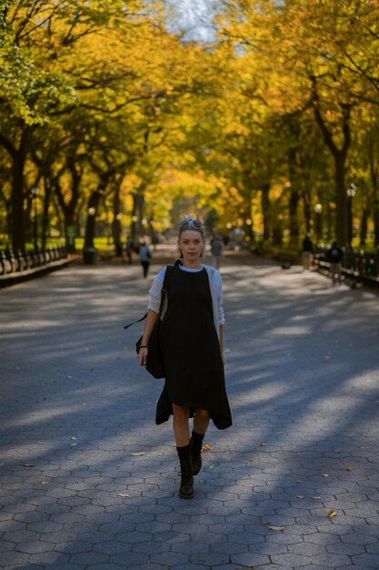 New York Manhattan Central Park in autumn, bridge over the lake. young woman walks in an autumn park in New York.