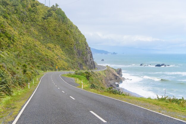 New Zealand Coastal Highway: A scenic road winds along the western shore of New Zealand's South Island.