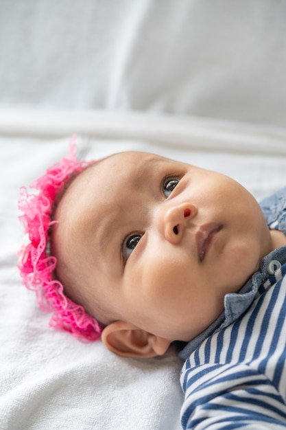 A newborn baby who opens his eyes and looks forward