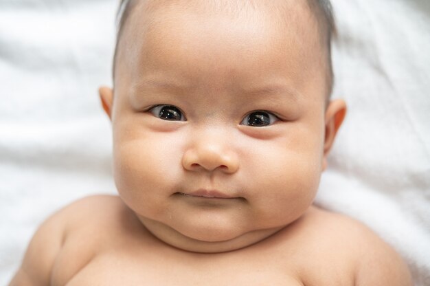 A newborn baby who opens his eyes and looks forward