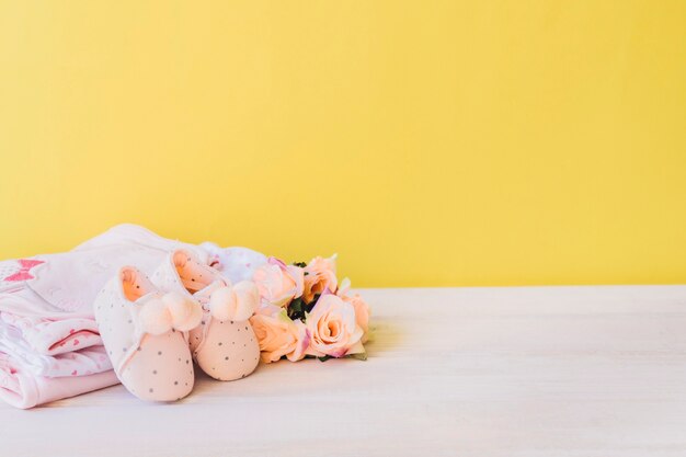 Newborn concept with clothes and rose