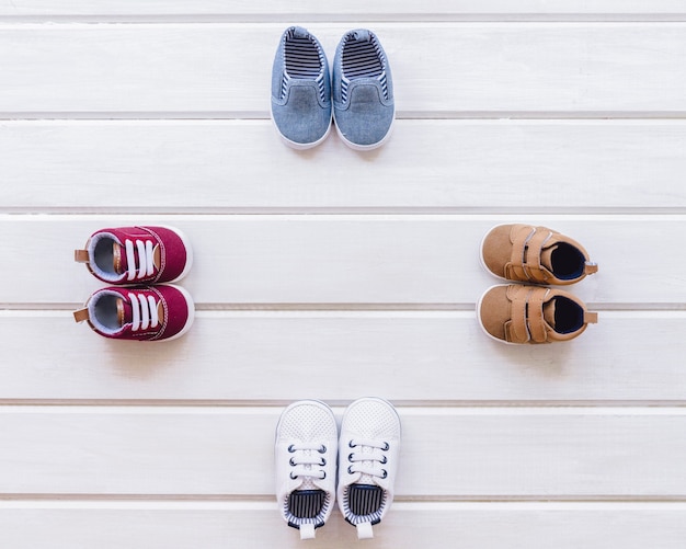 Free photo newborn concept with four pairs of shoes