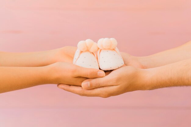 Newborn concept with holding hands and shoes