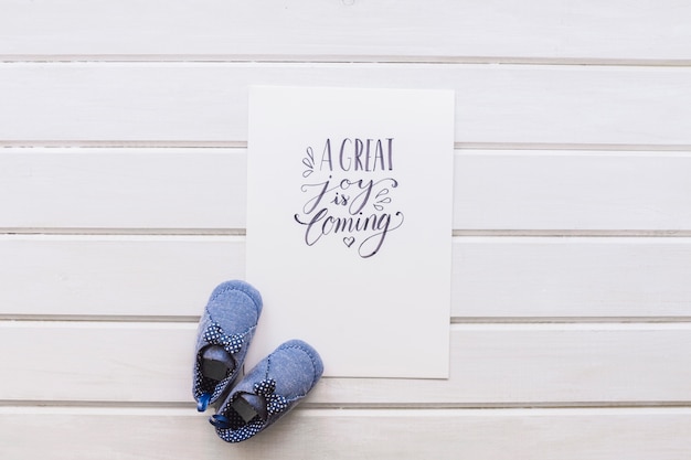 Free photo newborn concept with paper and shoes