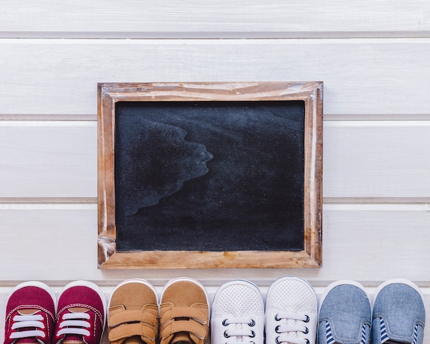 Newborn concept with slate and shoes