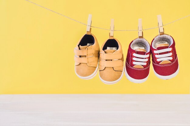 Newborn concept with two shoes on clothesline