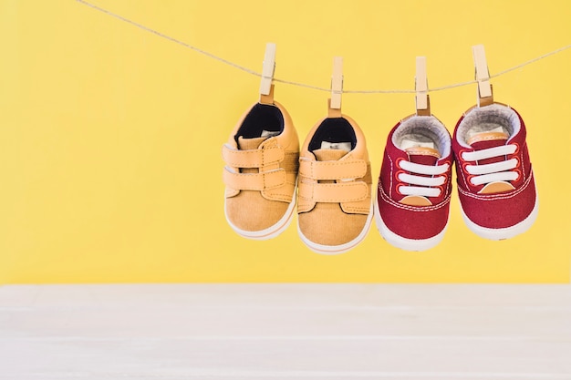 Newborn concept with two shoes on clothesline