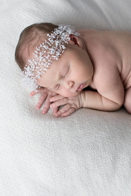 Free photo newborn sleeping on stomach light background real life lifestyle