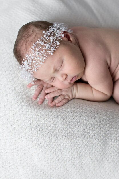 Newborn sleeping on stomach light background real life lifestyle