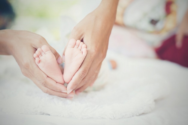 Newbron Baby feet in the mother hands.