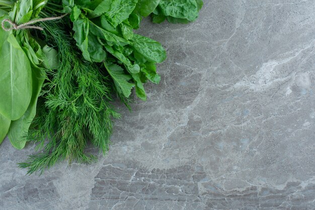 Newly harvested greens, on the marble table. 