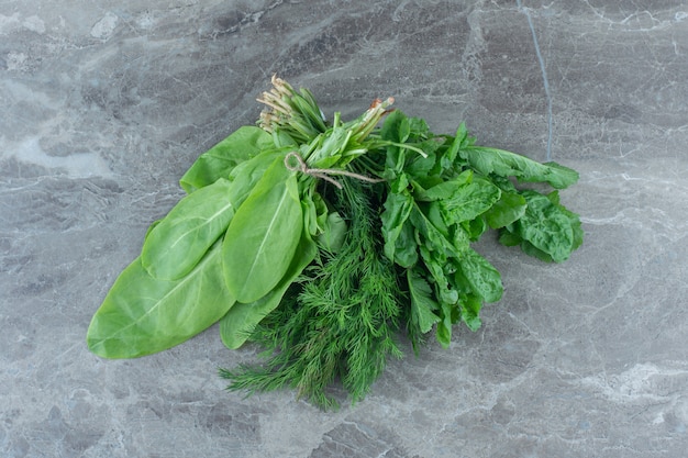 Newly harvested greens, on the marble table. 