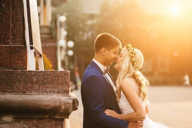 Newlywed couple kissing in street