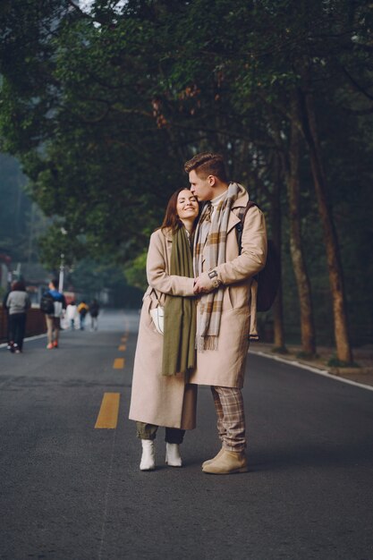 Newlywed couple showing affection and holding hands as they are walking through the zhangjiajie national forest park
