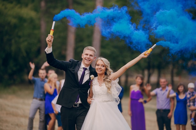 Free photo newlyweds holding flares