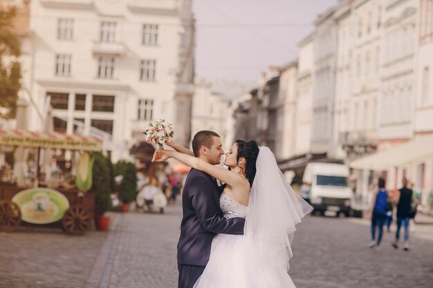 Newlyweds hugging with blurred background