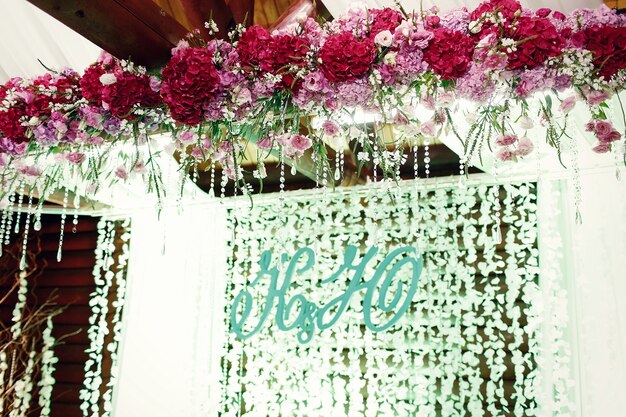 Newlyweds' initials stand hang before the light garlands