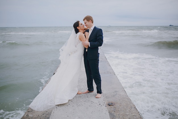 Newlyweds kissing in the sea
